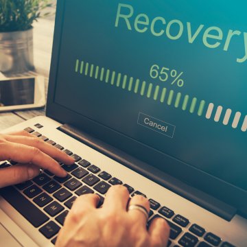 picture of hands fixing a laptop