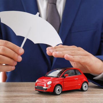 Toy car protected by big hands