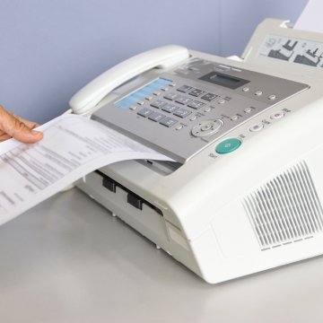Old fax machine receiving a message