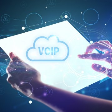 Voip phone system in the cloud on a screen with a hand overtop of it. 