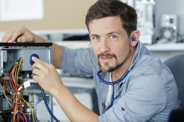 Computer technician checking to see if a computer is broken 