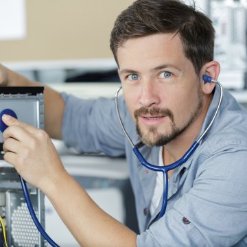 Computer technician checking to see if a computer is broken 