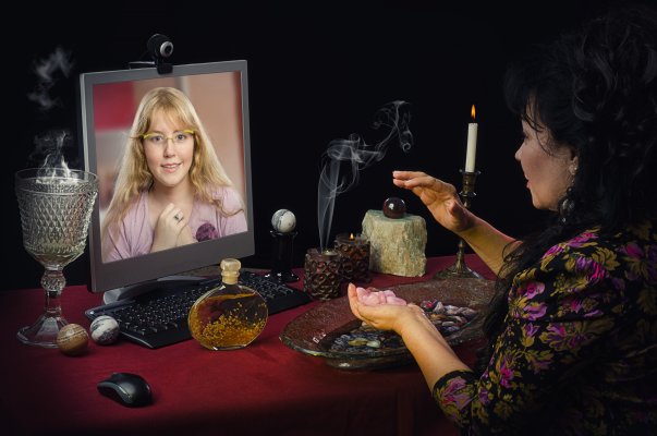 woman reading through laptop online psychic services kasamba keen