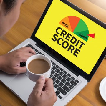 man drinking coffee in front of the laptop checking credit scores credit monitoring 