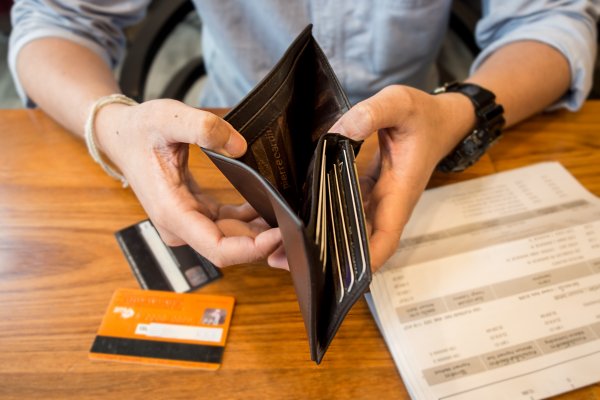 man checking empty wallet debt consolidation