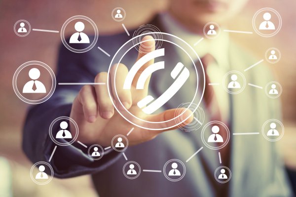 voip services vonage benefits man in suit pressing on call digital online call 