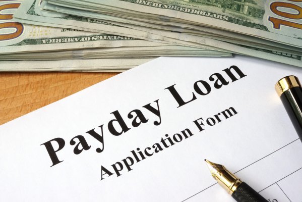 check into cash payday loans fees application form pen dollar bills