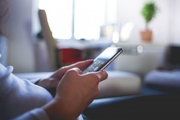 man on smartphone, checking phone, background check, been verified