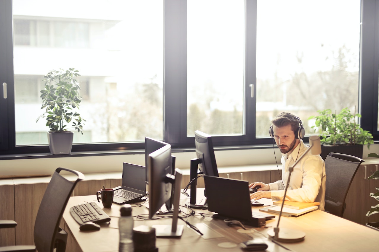 person on their computer and phone helping a customer