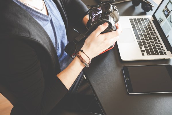 woman holding a camera, photos, laptop, photo book, picaboo