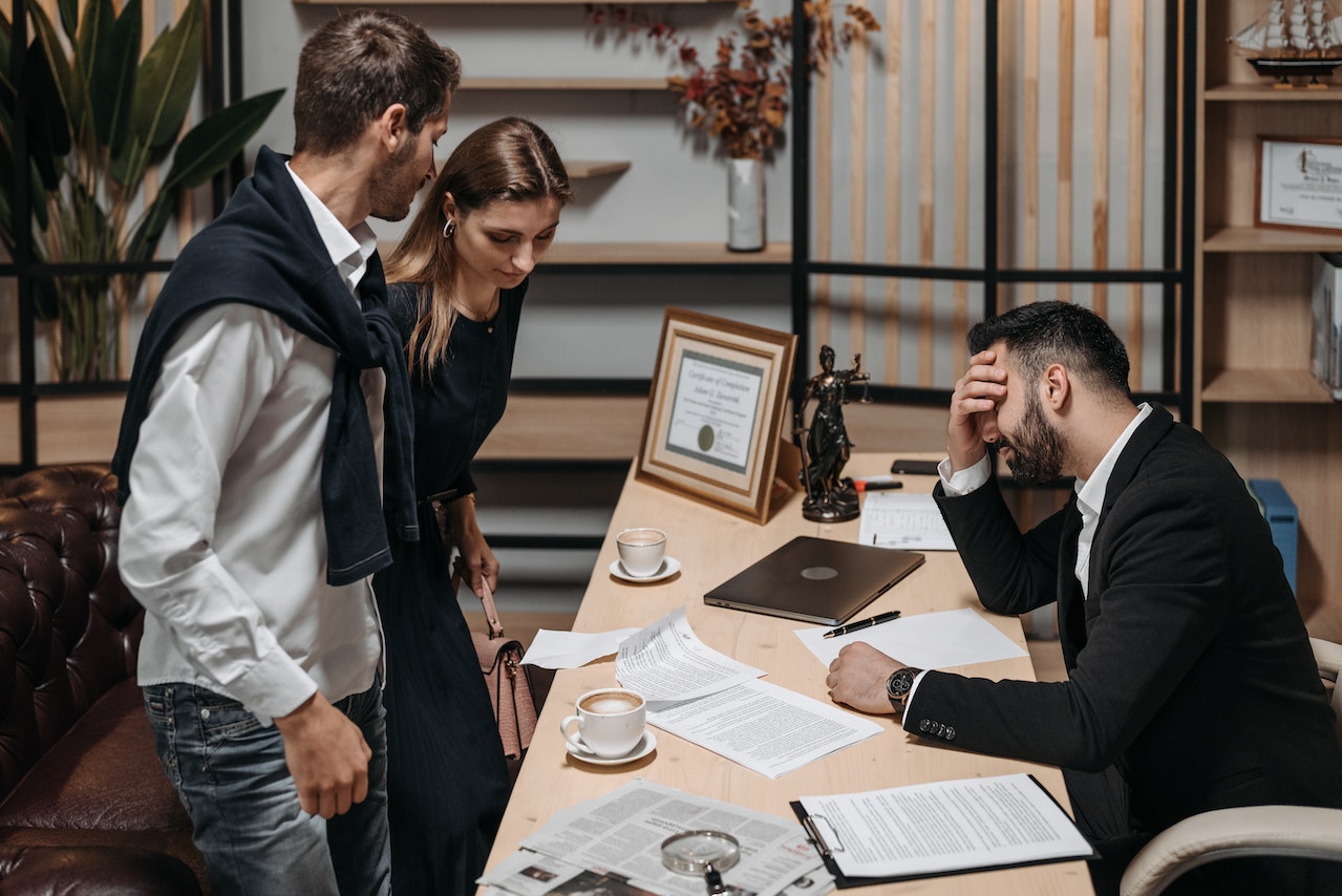 a lawyer having a discussion with their clients in an office