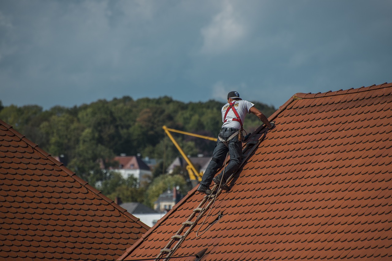 person changing the roofing tiles