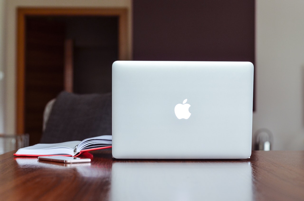 apple laptop open with the logo displayed