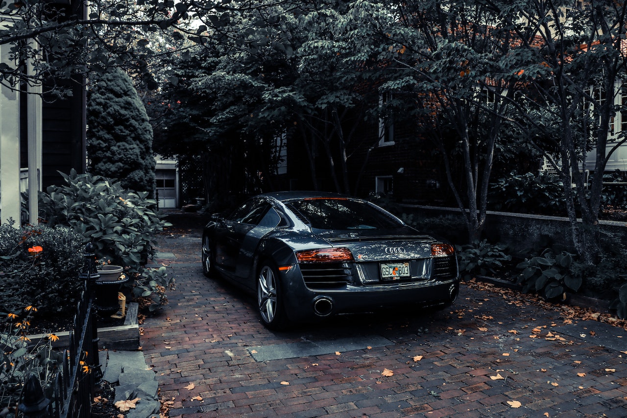 black audi r8 parked beside a house