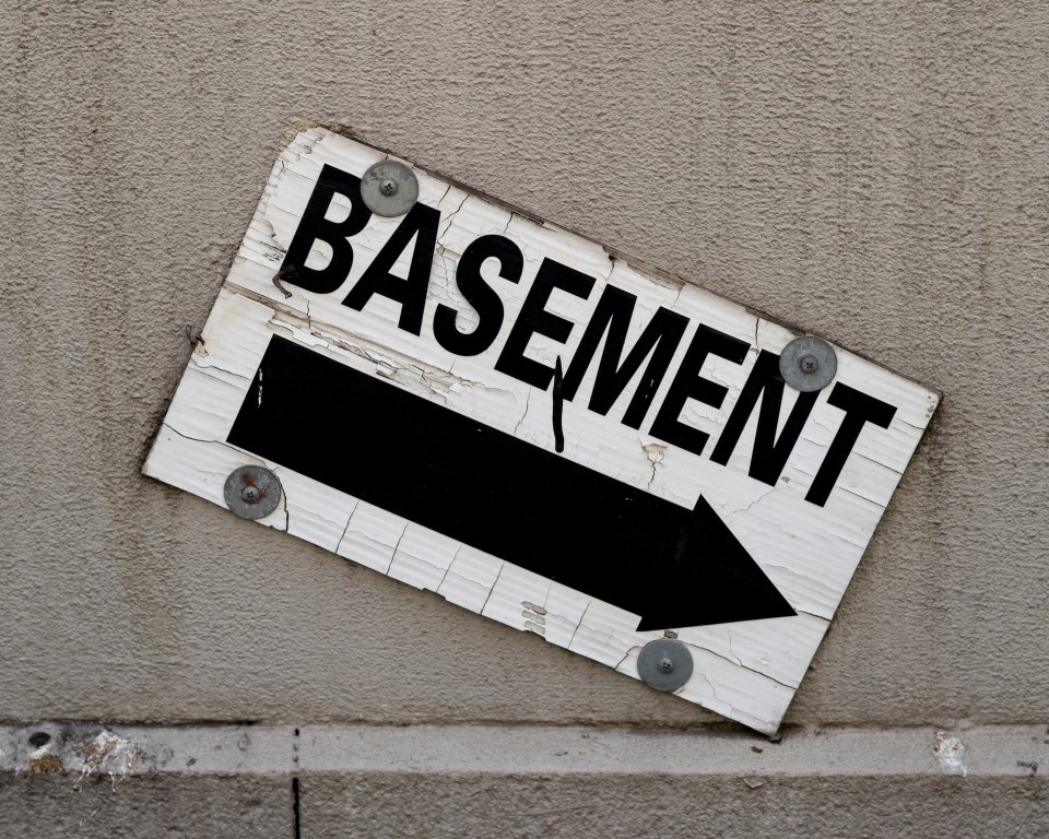 a sign pointing towards the basement