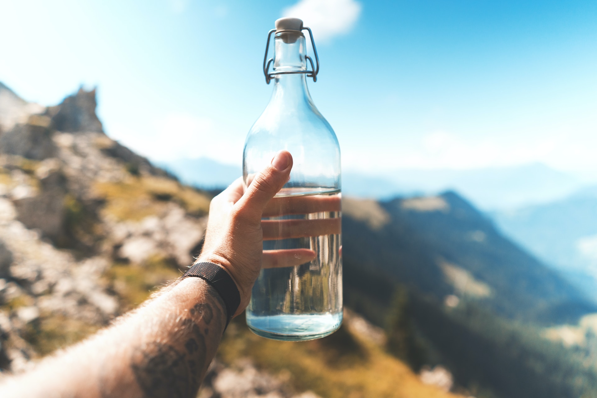 hiking on a mountain with glass bottled water