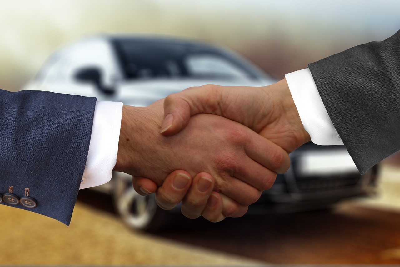 shaking hands over a car deal
