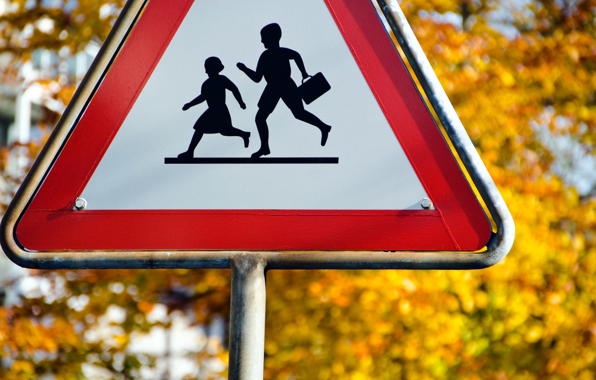 triangle sign with children playing icon in the middle of it