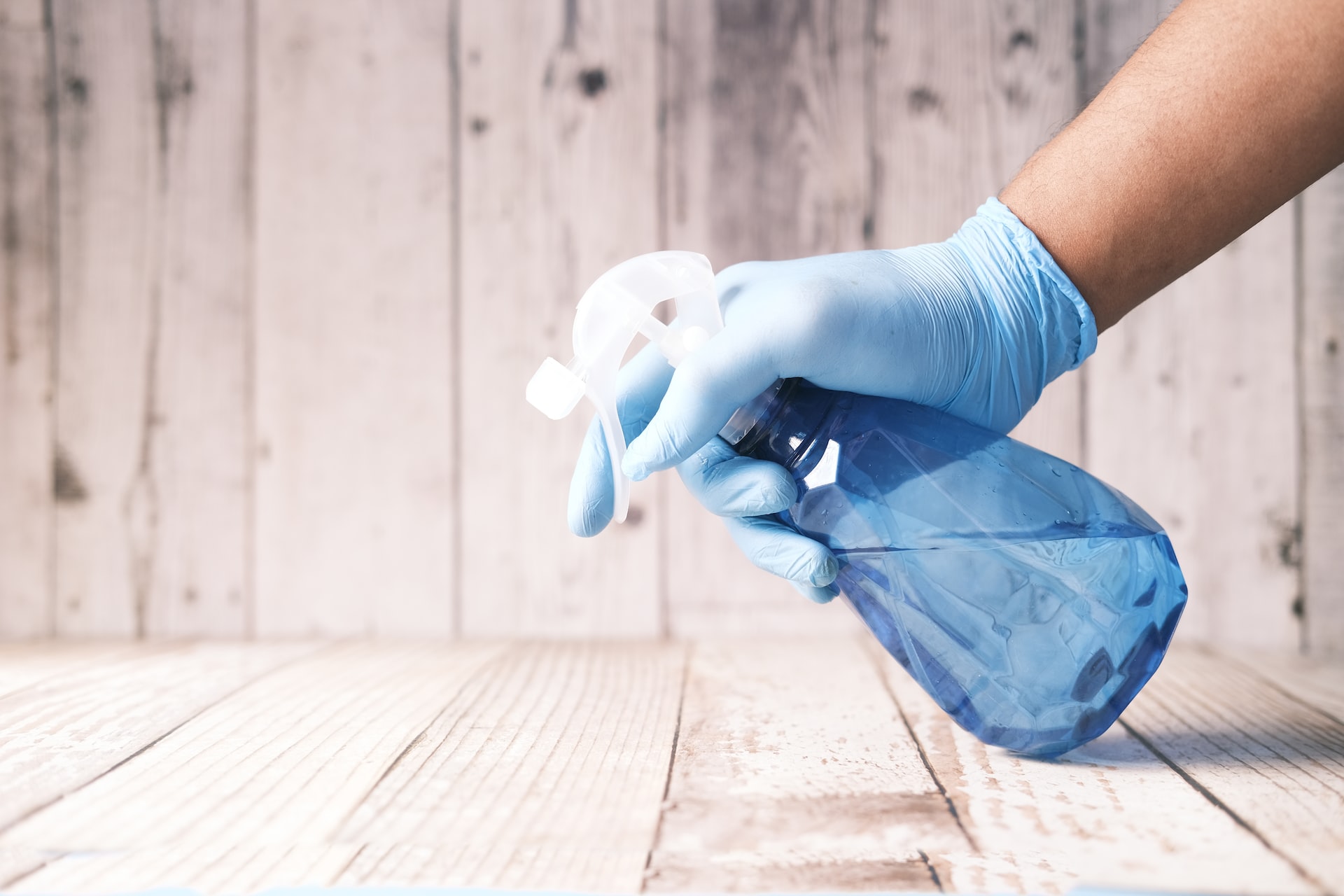 spraying an area to clean with a bottle