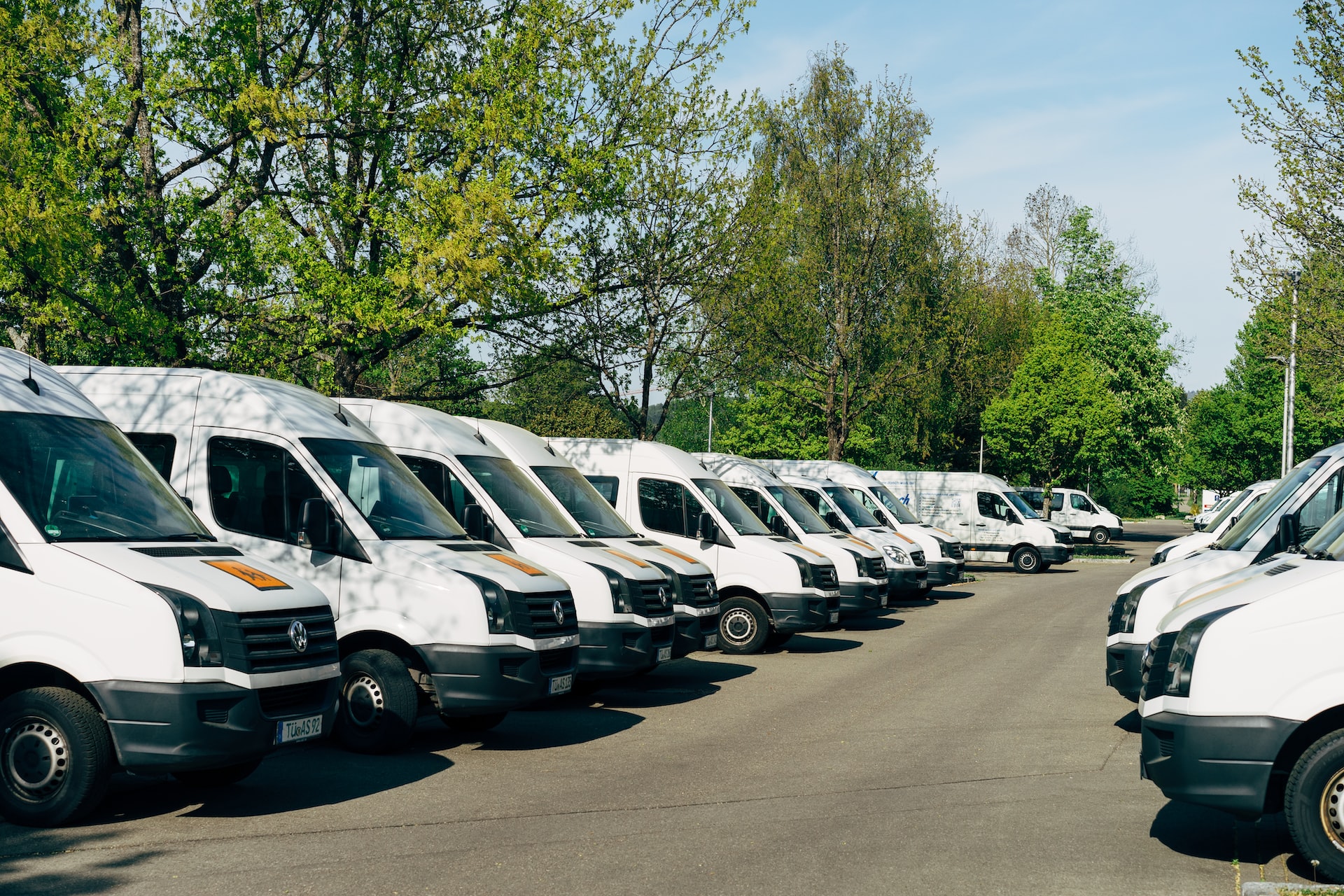 white commercial vans parked in a lot