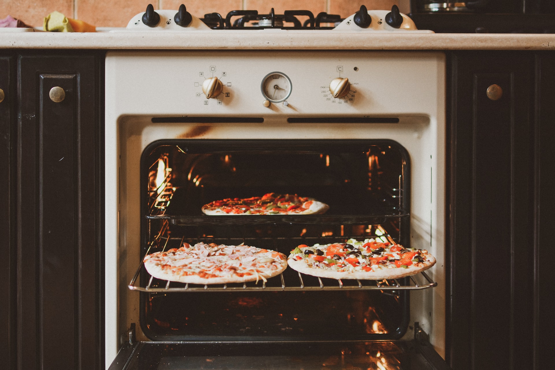 pizza oven with three pizzas going in