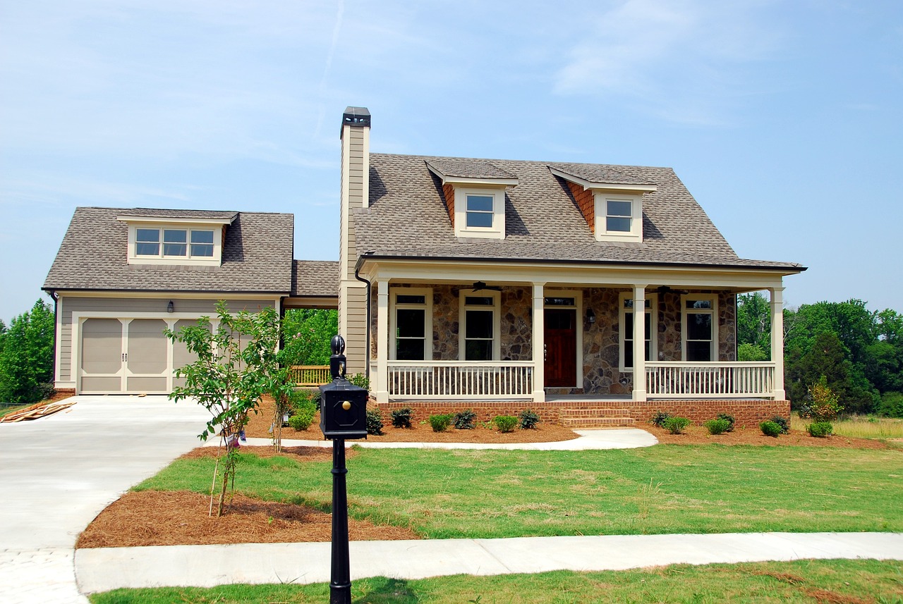 nice curb side picture of a brown house with nice trim