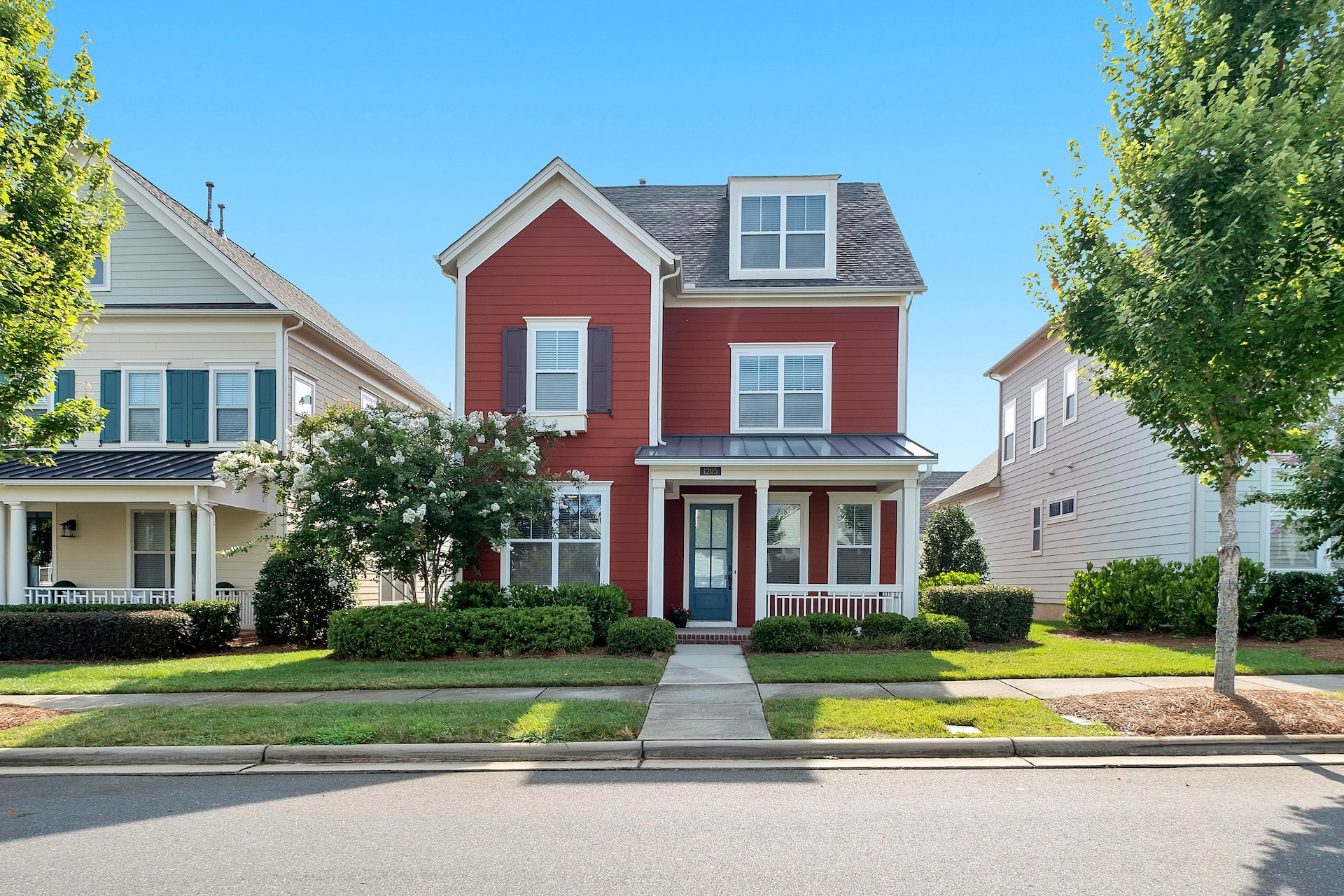 nice red house with a picture taken from the street