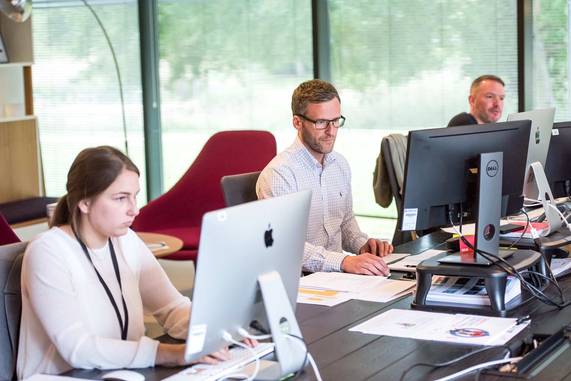 team of customer support agents at desks helping users