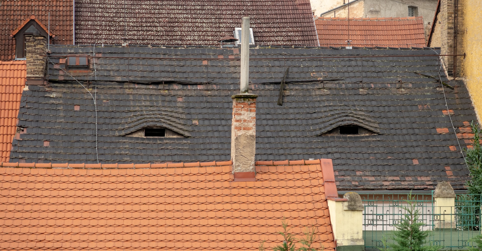 a darker roof warping due to weather exposure