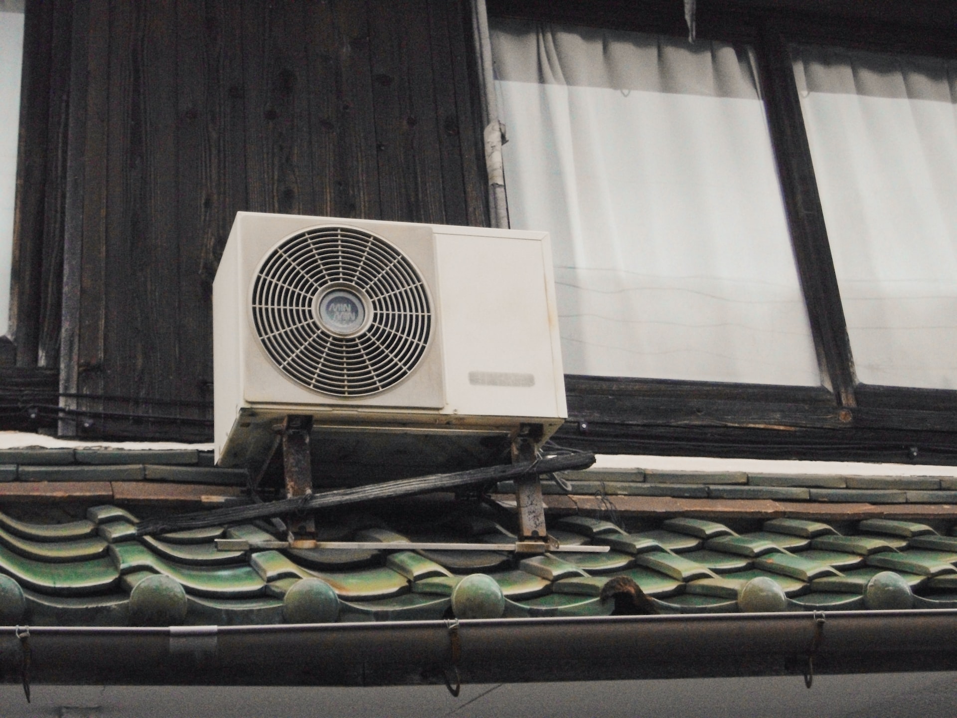 ac unit on a roof outside of a house