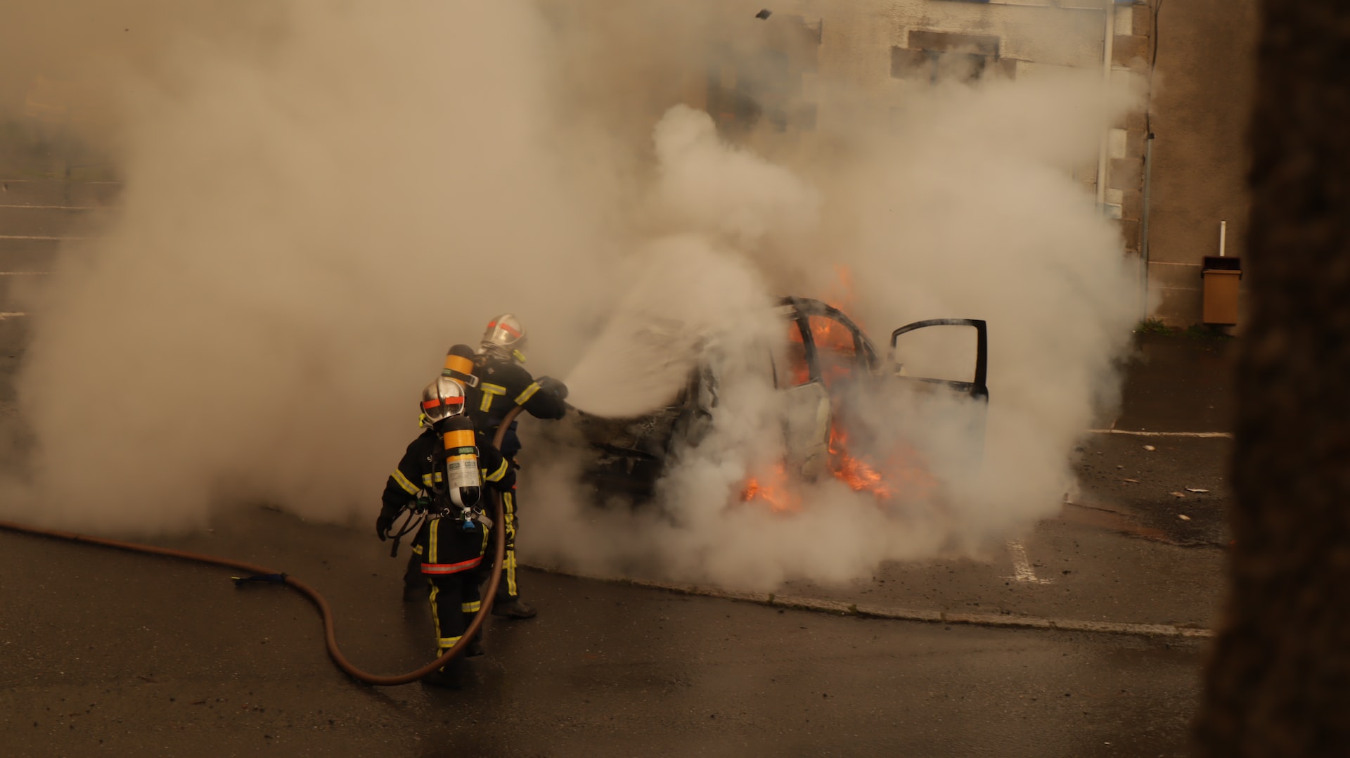 firefighters putting out a car that is on fire