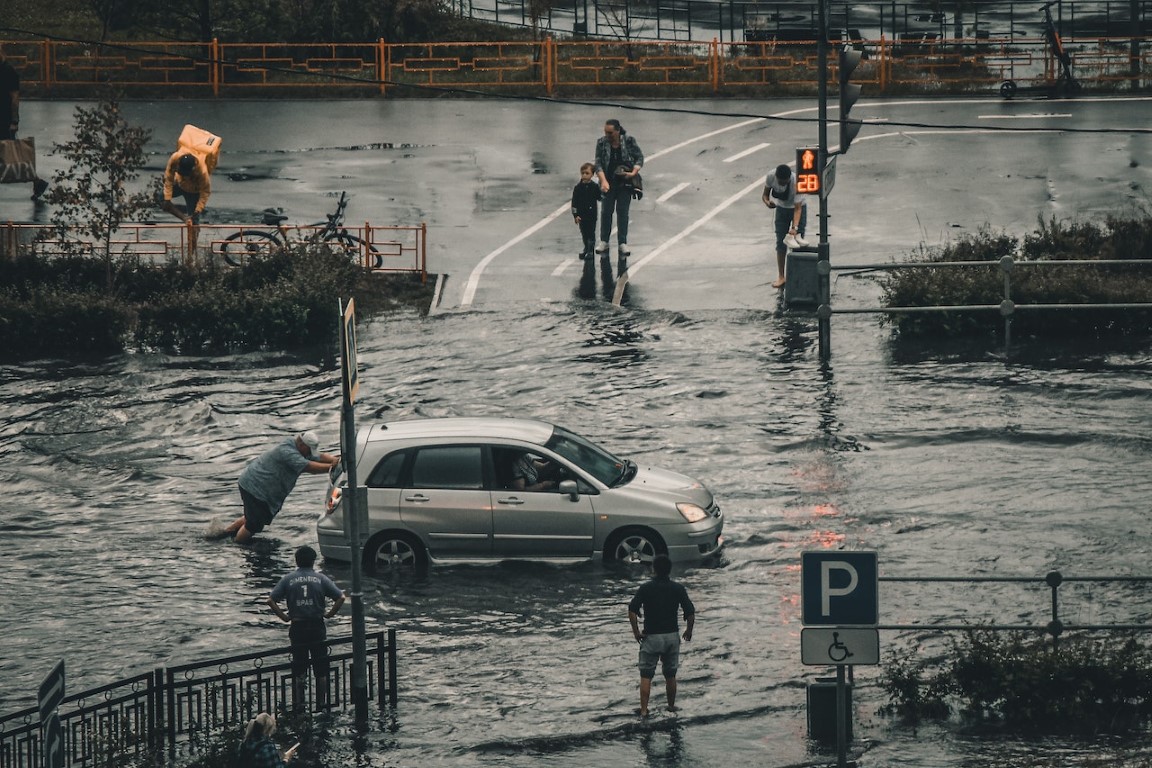 car being pushed in a flooded street