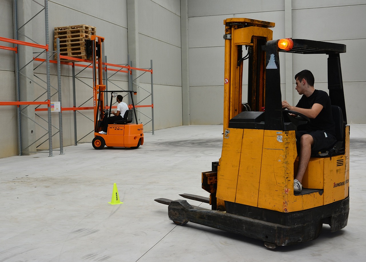 a forklift with a rider in a wharehouse