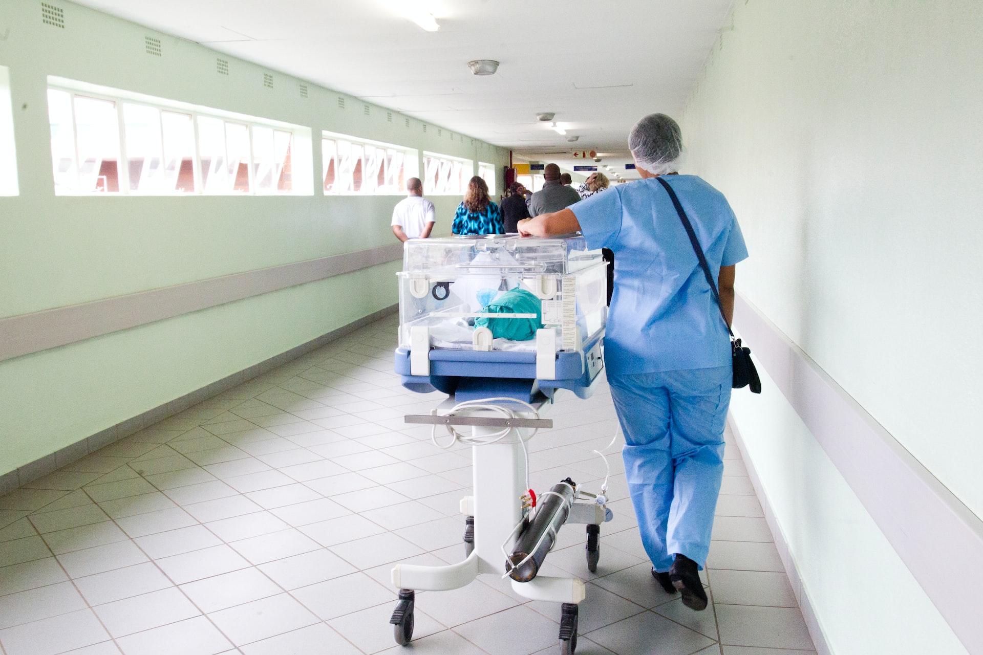triage team walking down a hallway in a hospital