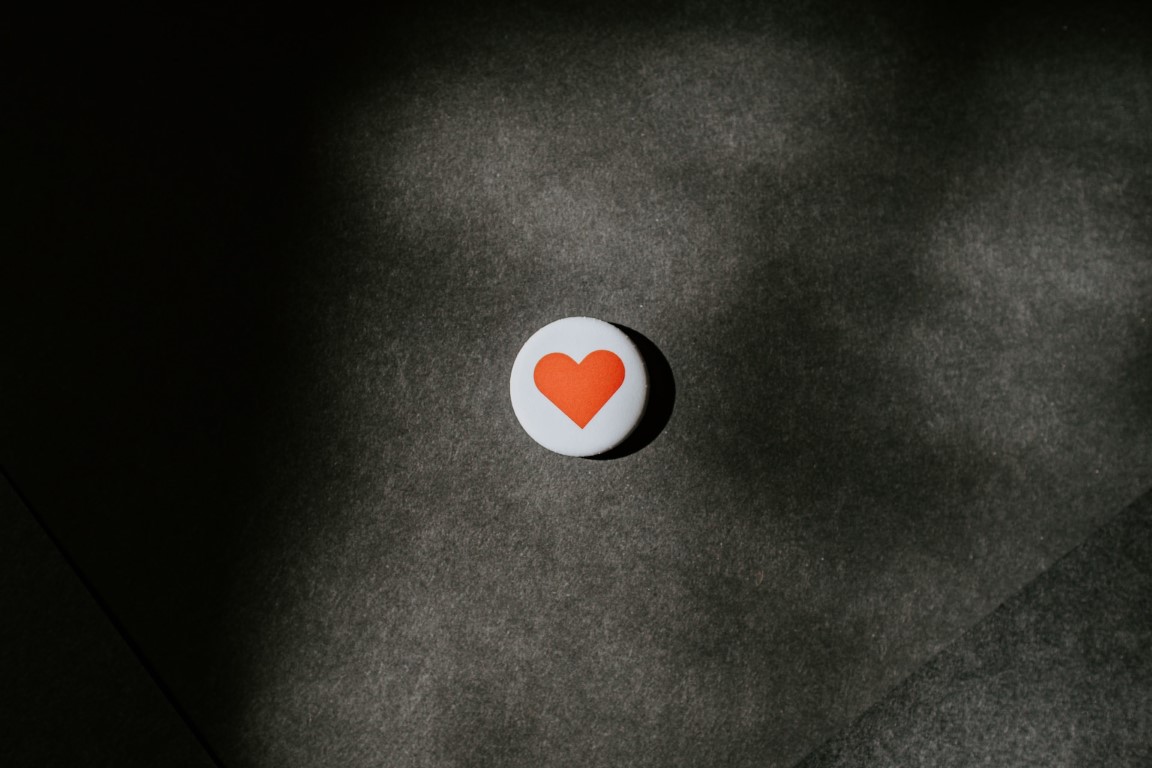 round pin with a heart on it