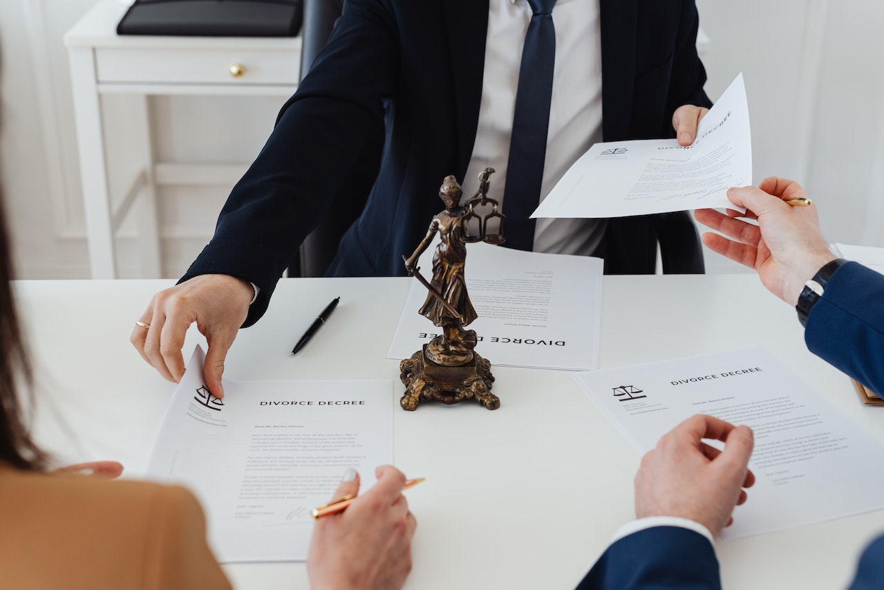 a lawyer and clients with papers on a table between them