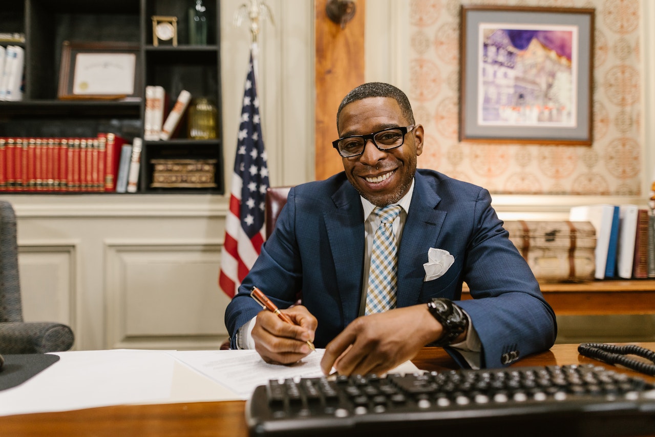 lawyer in a blue suit sitting at a desk