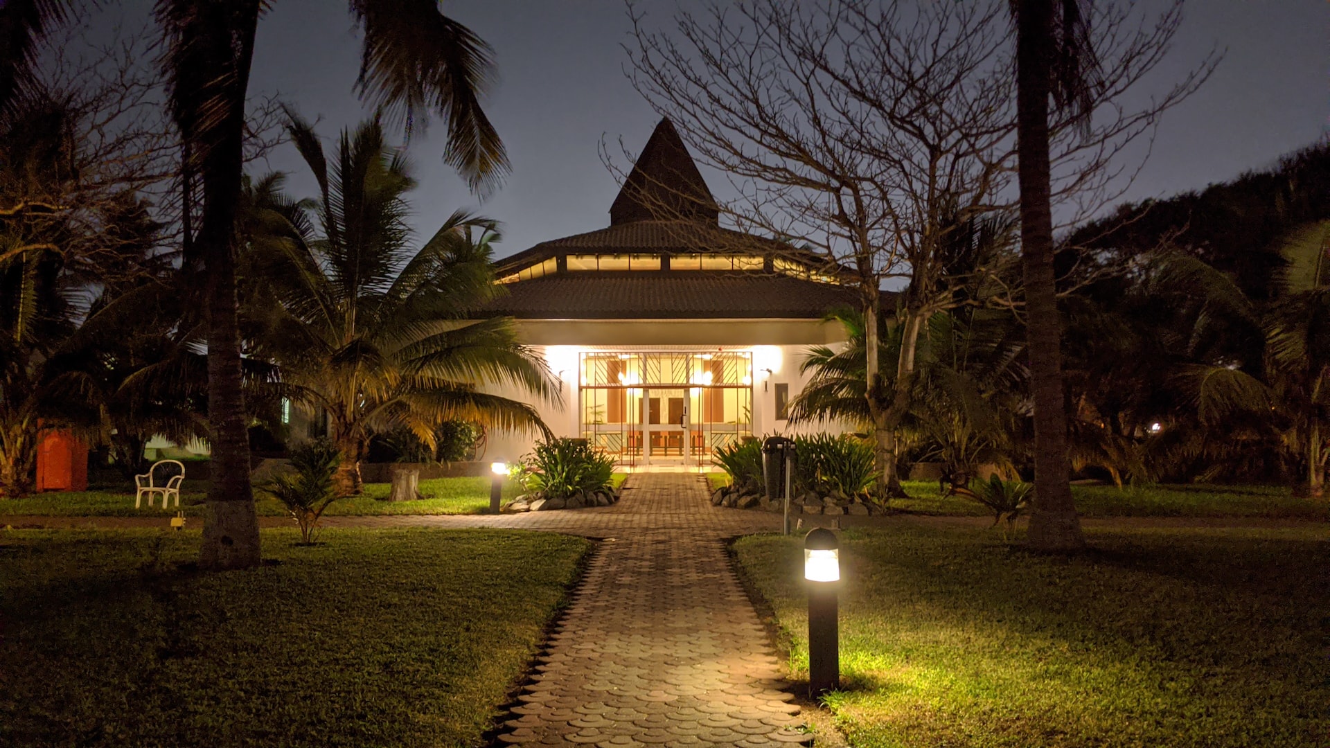 a backyard lit up nicely with led lights by a path