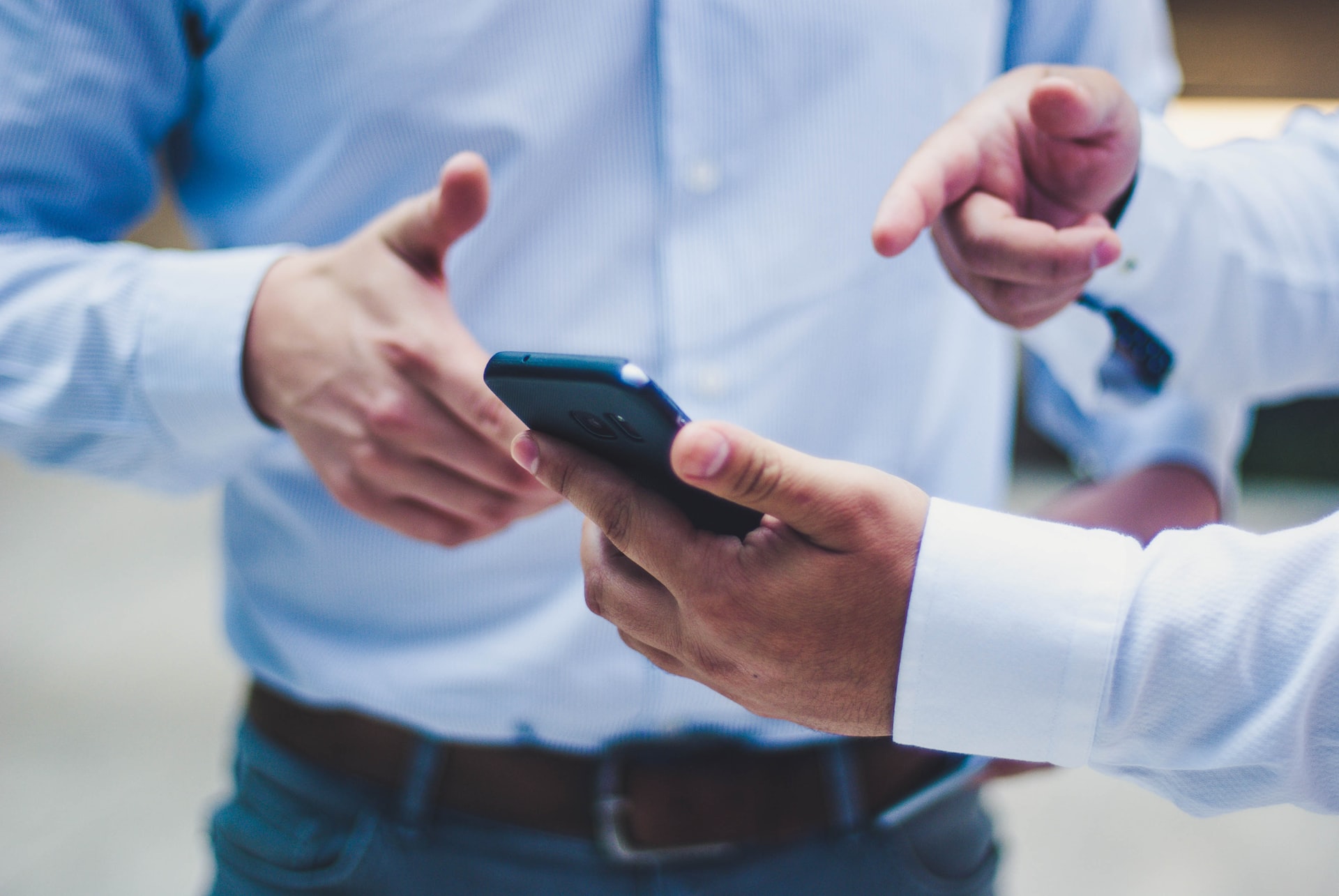 two people looking at a cell phone