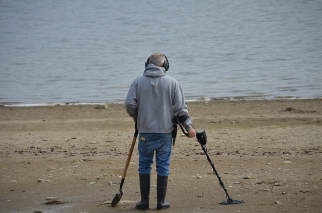 Using a metal detector on a beach