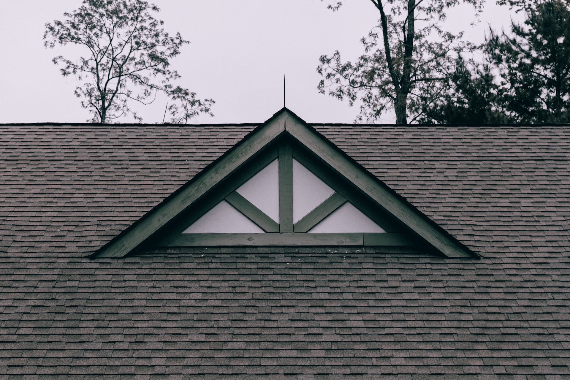 a window on a roof covered by new asphalt shingles 