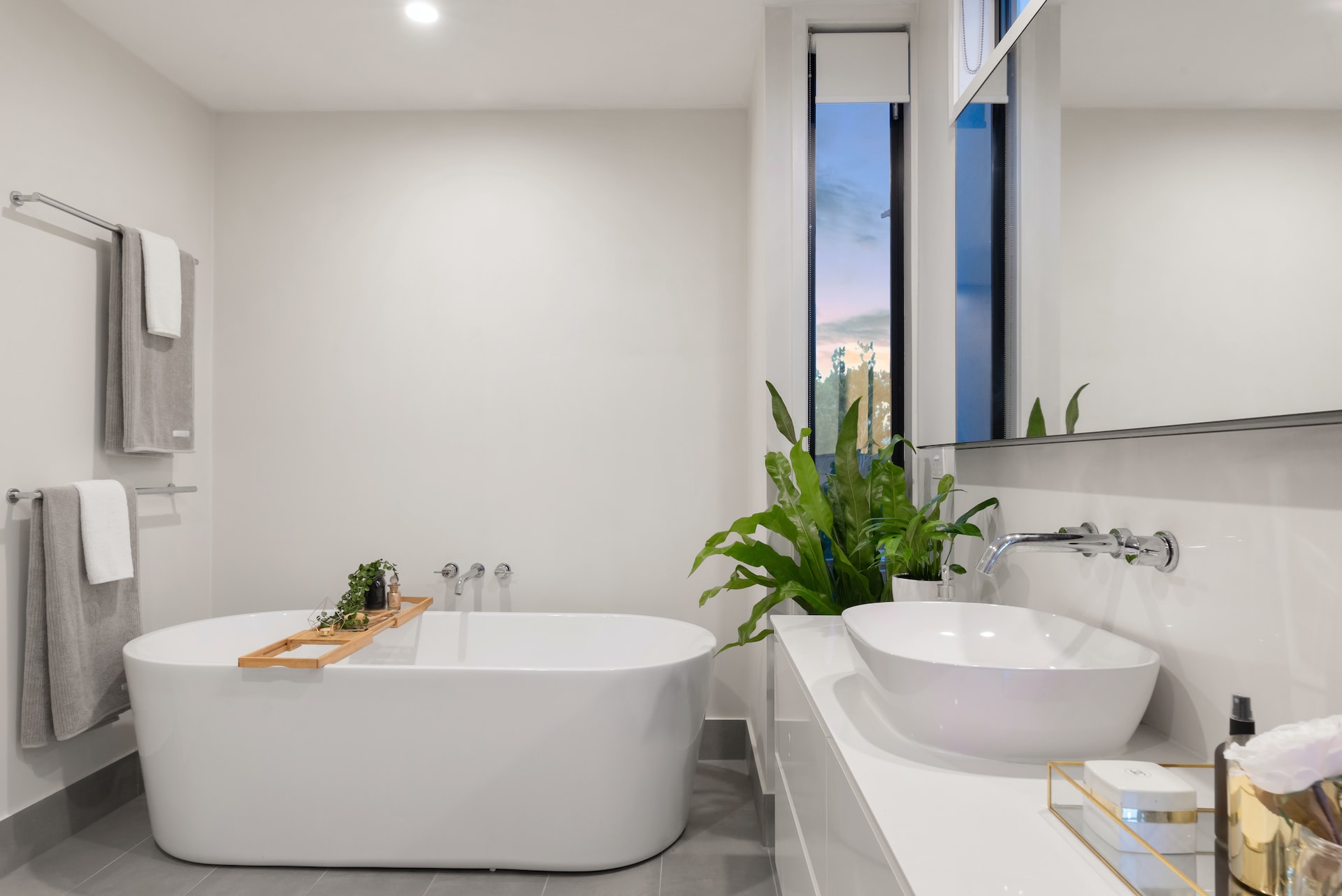 white bathroom theme with modern white bathtub
