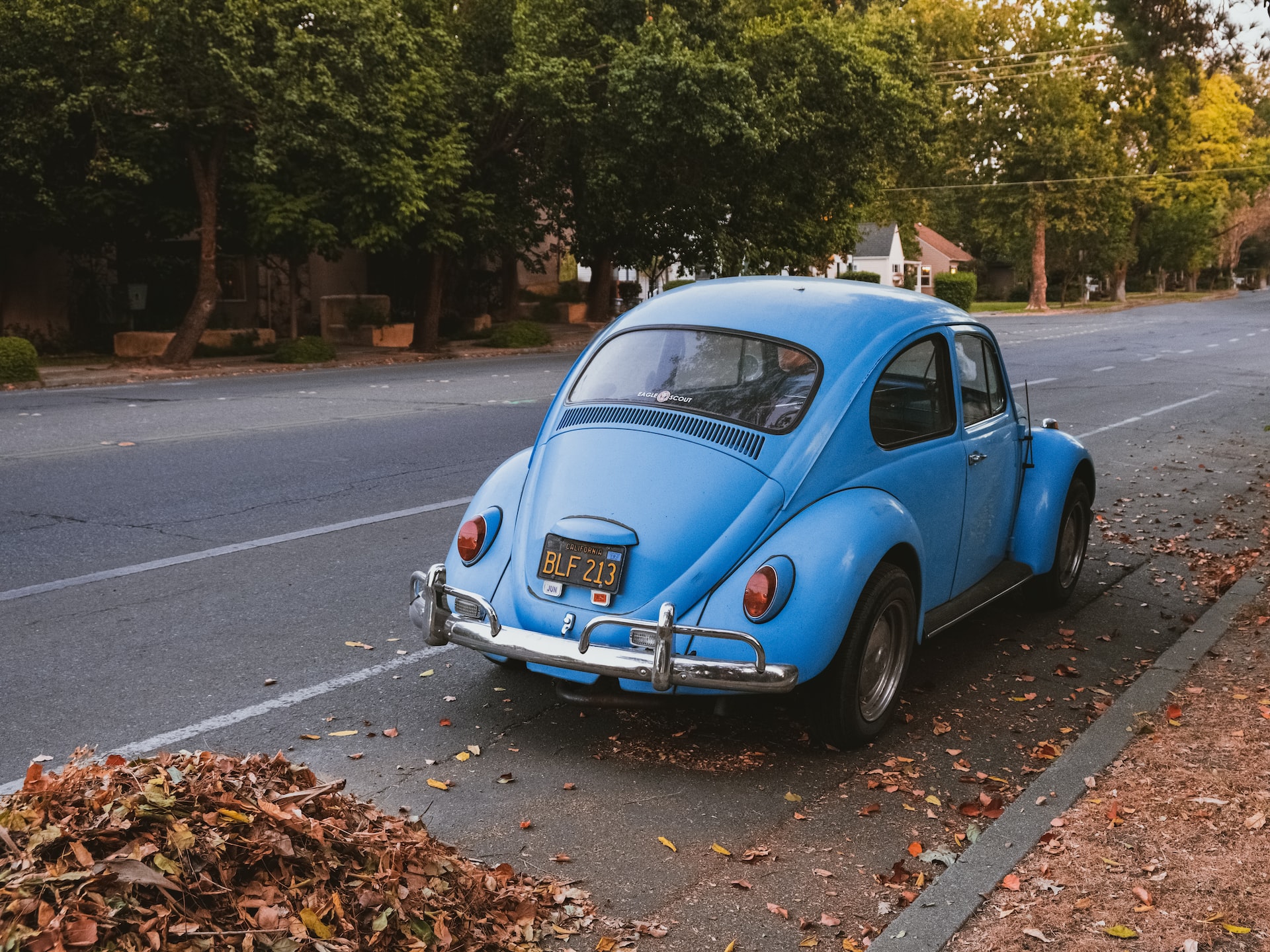 old school vw bug parked on the side of the road