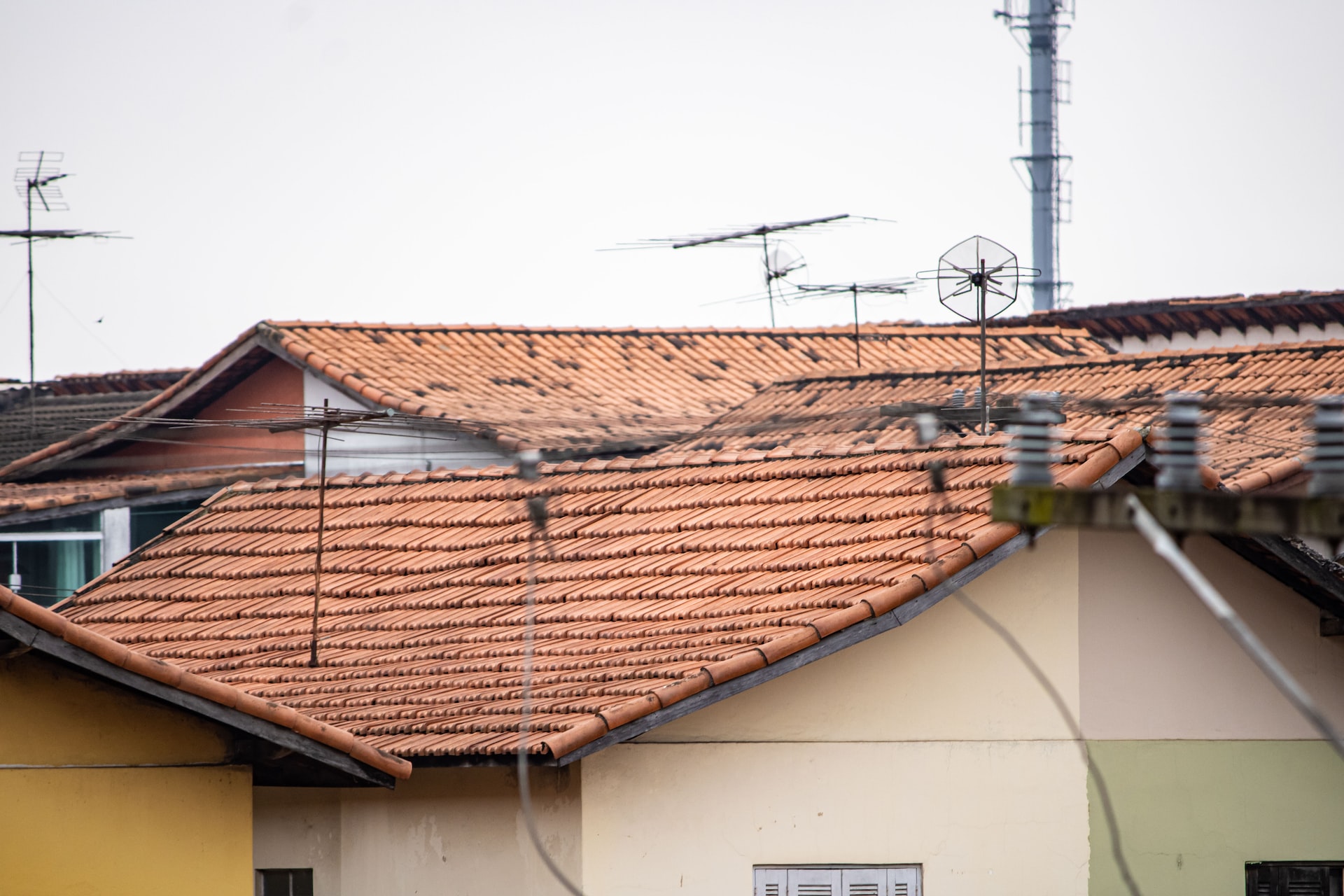 clay tiles on a roof falling apart due to age