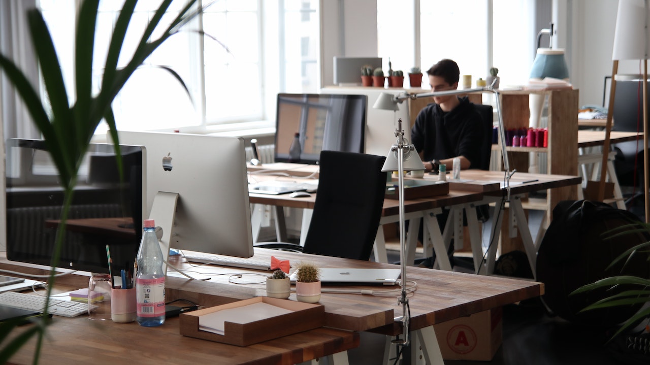 person at work station in an open concept office