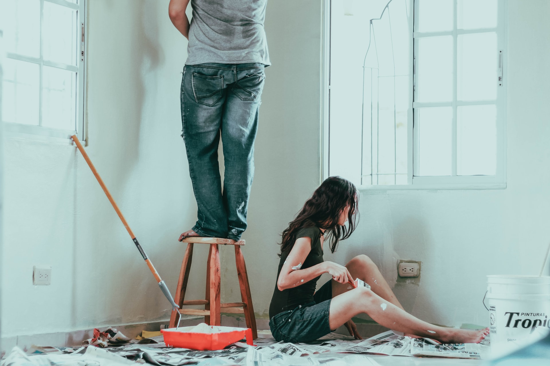 two people painting a room