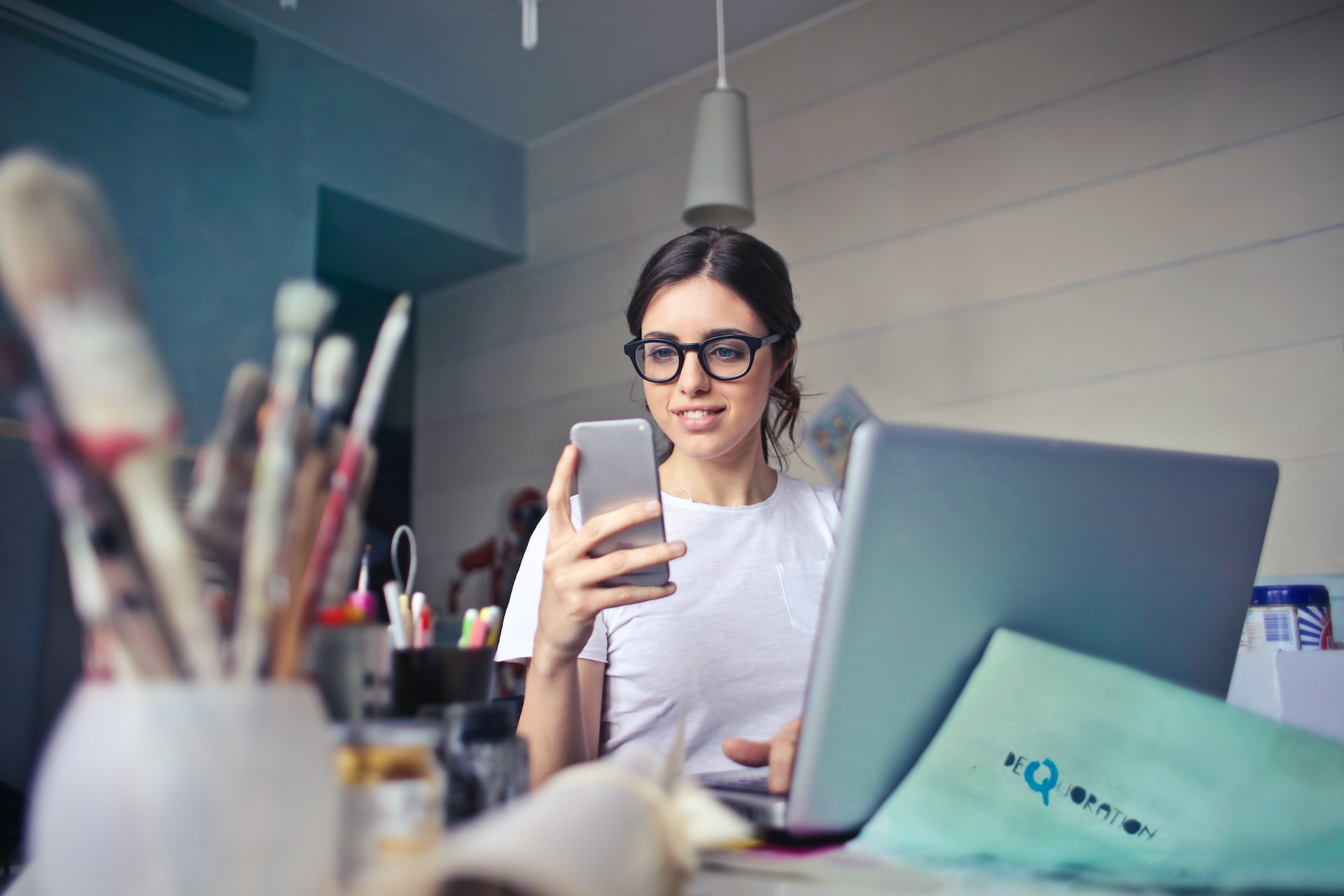 a person looking at their cell phone in a room