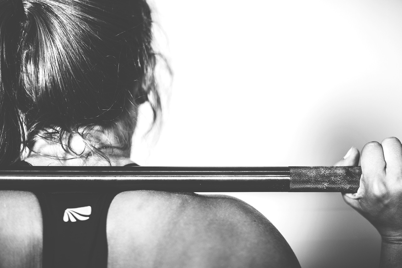 a workout bar on someones shoulder