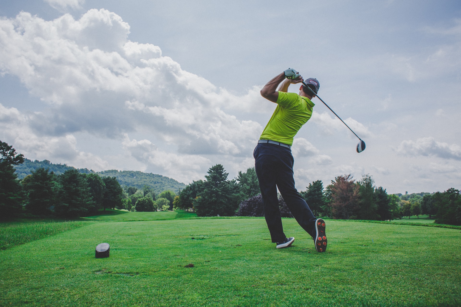 teeing off on an outdoor golf course