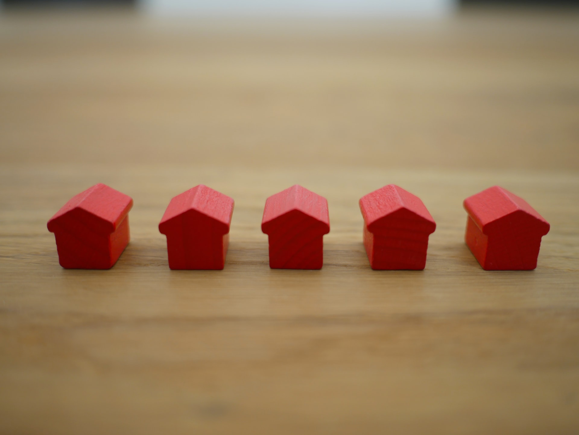 tiny red houses like the ones from a board game on a table